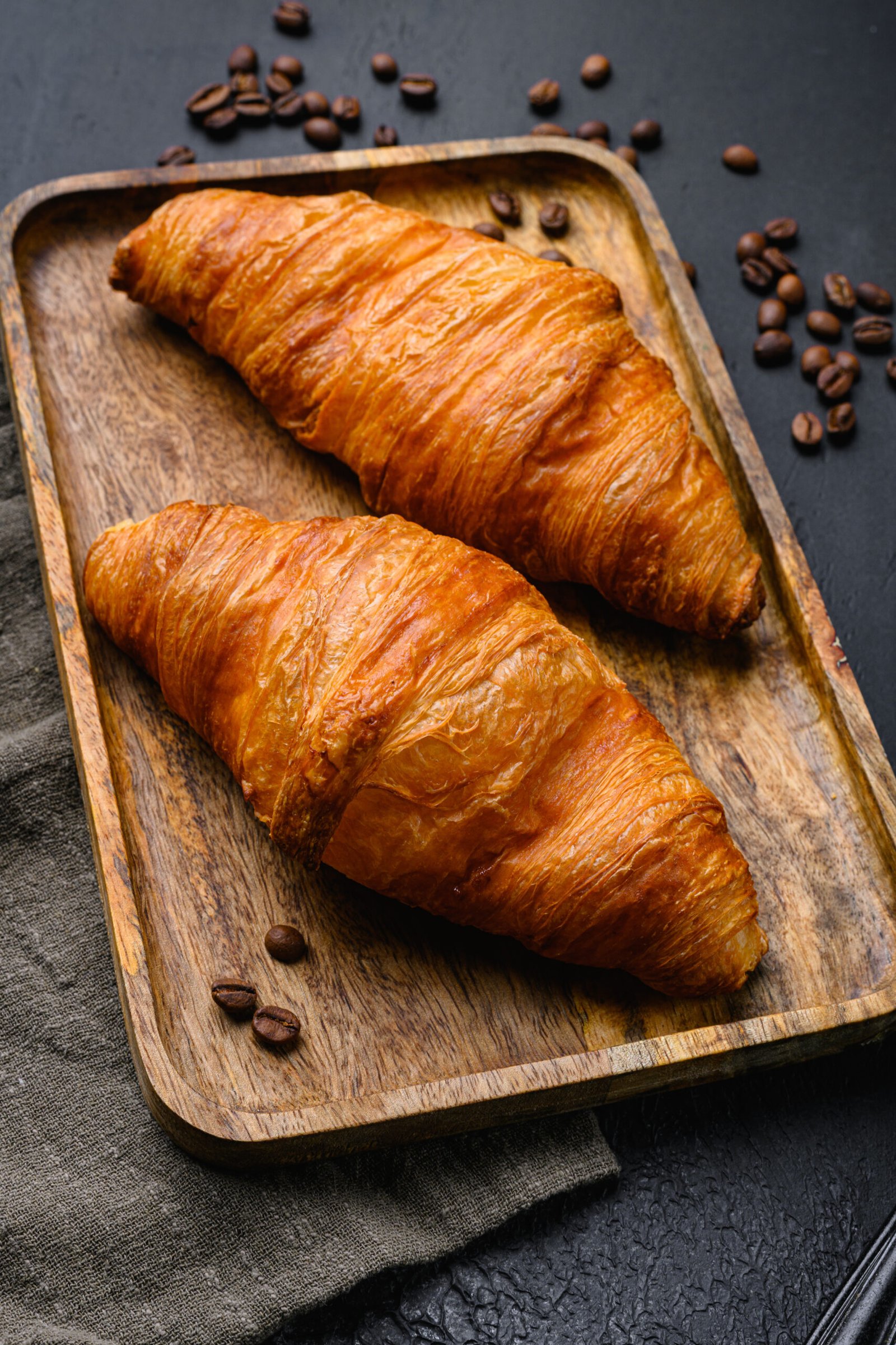 Warm butter creamy baked croissants set, on black dark stone tab